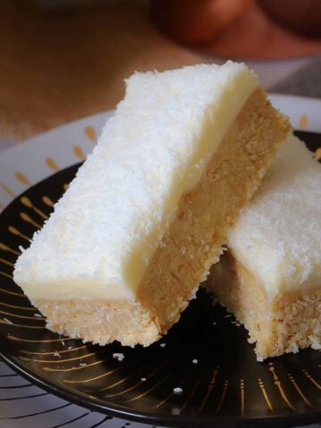 This new and improved Lemon & Coconut Slice recipe is absolutely perfect! A beautiful tangy base topped with a creamy lemon frosting... it seriously doesn't get any better than this!