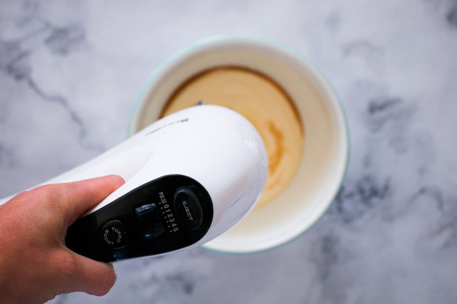 Hand held beaters whipping cream.